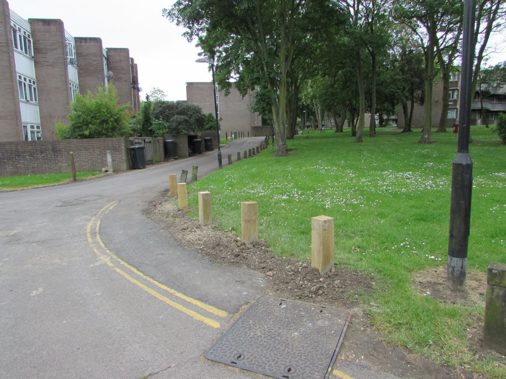 New wooden bollards on the service road