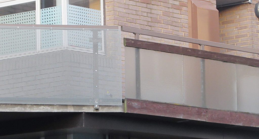 A section of the metal sheeting next to the original glass and wood.